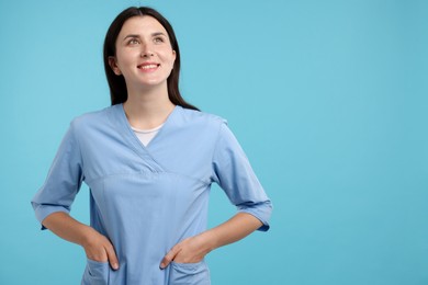 Photo of Nurse in uniform on light blue background, space for text