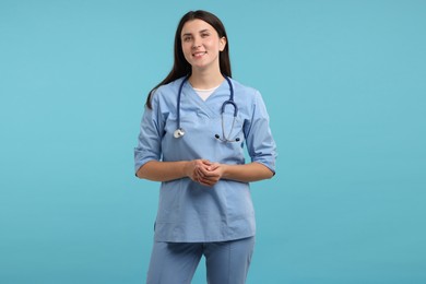 Photo of Nurse with stethoscope on light blue background