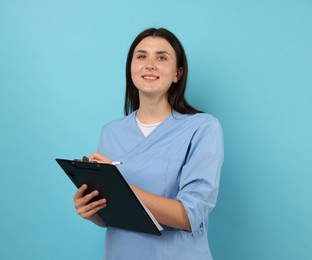 Photo of Nurse with clipboard taking notes on light blue background