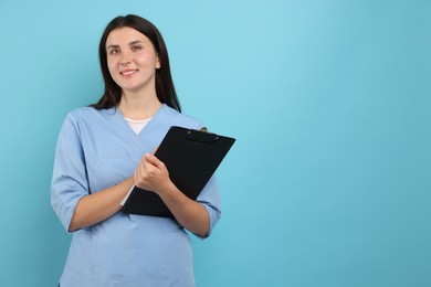 Photo of Nurse with clipboard on light blue background, space for text