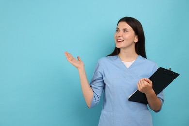 Photo of Nurse with clipboard on light blue background, space for text