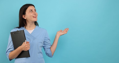 Photo of Nurse with clipboard on light blue background, space for text