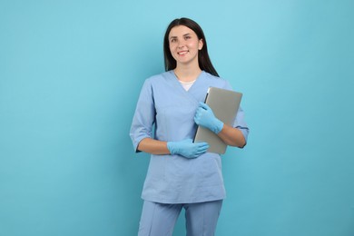 Photo of Nurse with laptop on light blue background