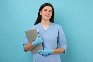 Photo of Nurse with laptop on light blue background