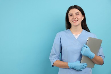 Photo of Nurse with laptop on light blue background, space for text