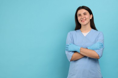 Photo of Nurse in uniform on light blue background, space for text