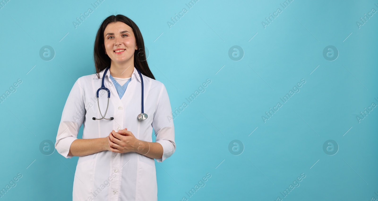 Portrait of nurse with stethoscope on light blue background, space for text Photo of Portrait of nurse with stethoscope on light blue background, space for text