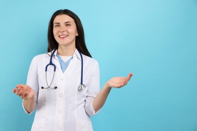 Photo of Portrait of nurse with stethoscope on light blue background, space for text