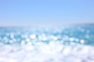 Photo of Blurred view of wavy sea and blue sky on sunny day