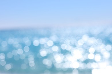 Photo of Blurred view of wavy sea and blue sky on sunny day