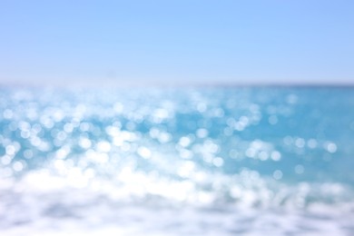 Photo of Blurred view of wavy sea and blue sky on sunny day