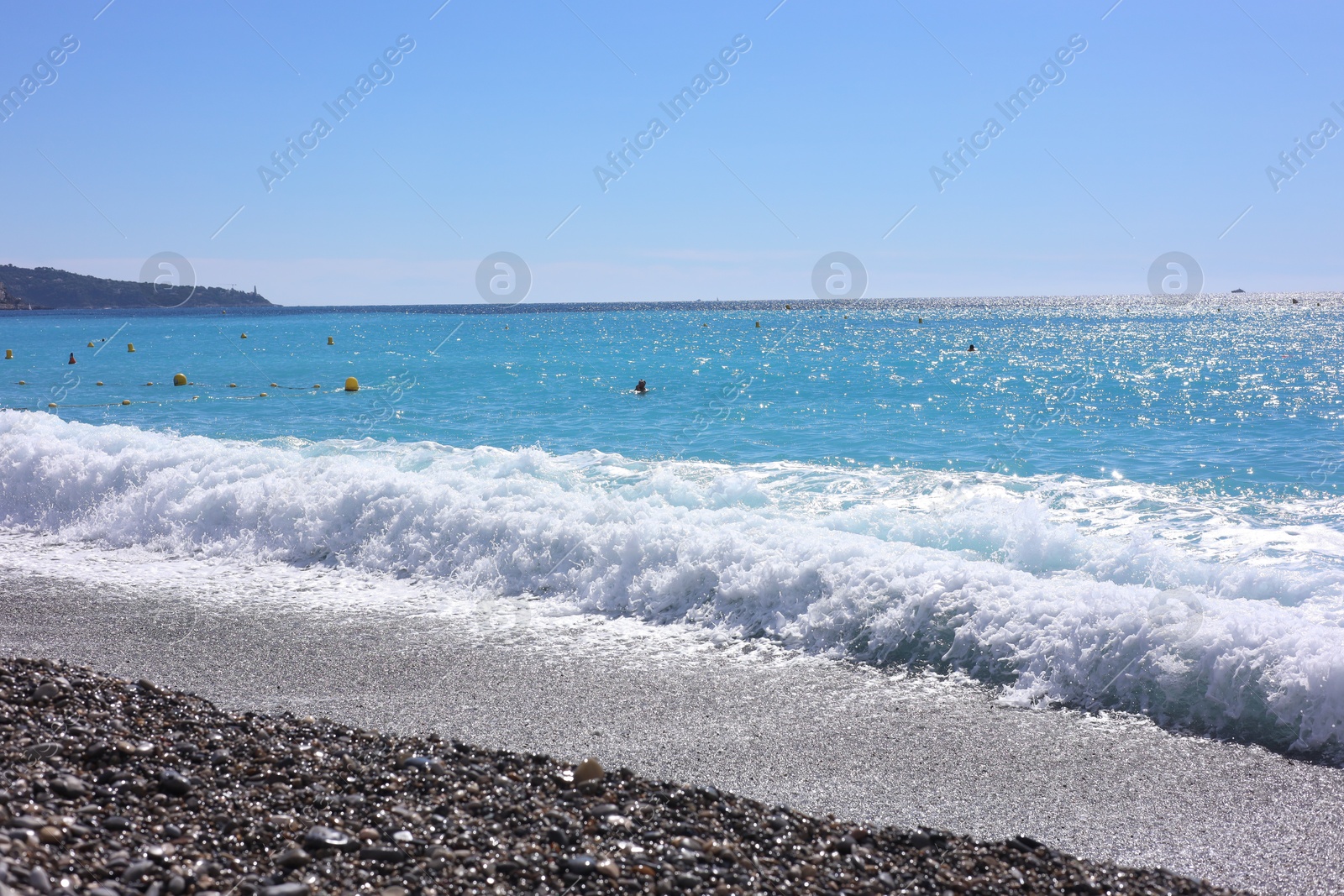 Photo of Beautiful view of wavy sea and pebbles on beach