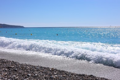 Photo of Beautiful view of wavy sea and pebbles on beach