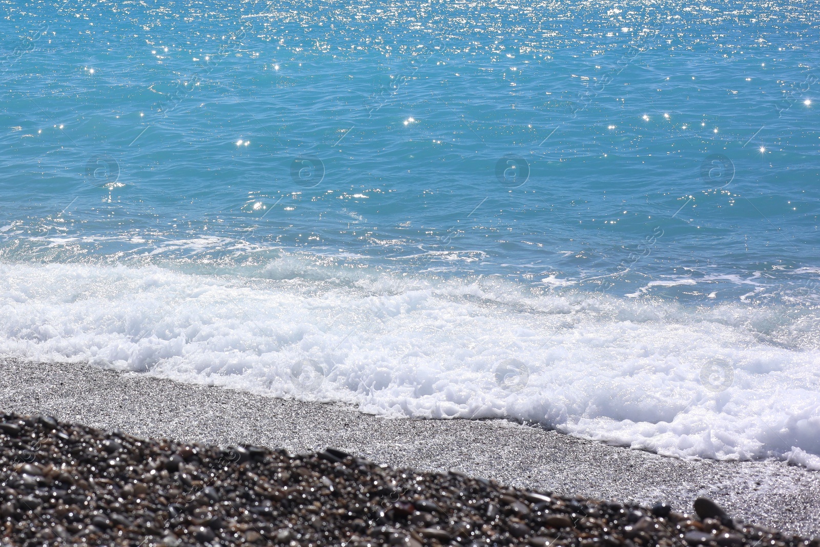Photo of Beautiful view of wavy sea and pebbles on beach