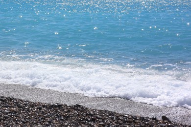 Photo of Beautiful view of wavy sea and pebbles on beach
