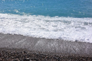Photo of Beautiful view of wavy sea and pebbles on beach