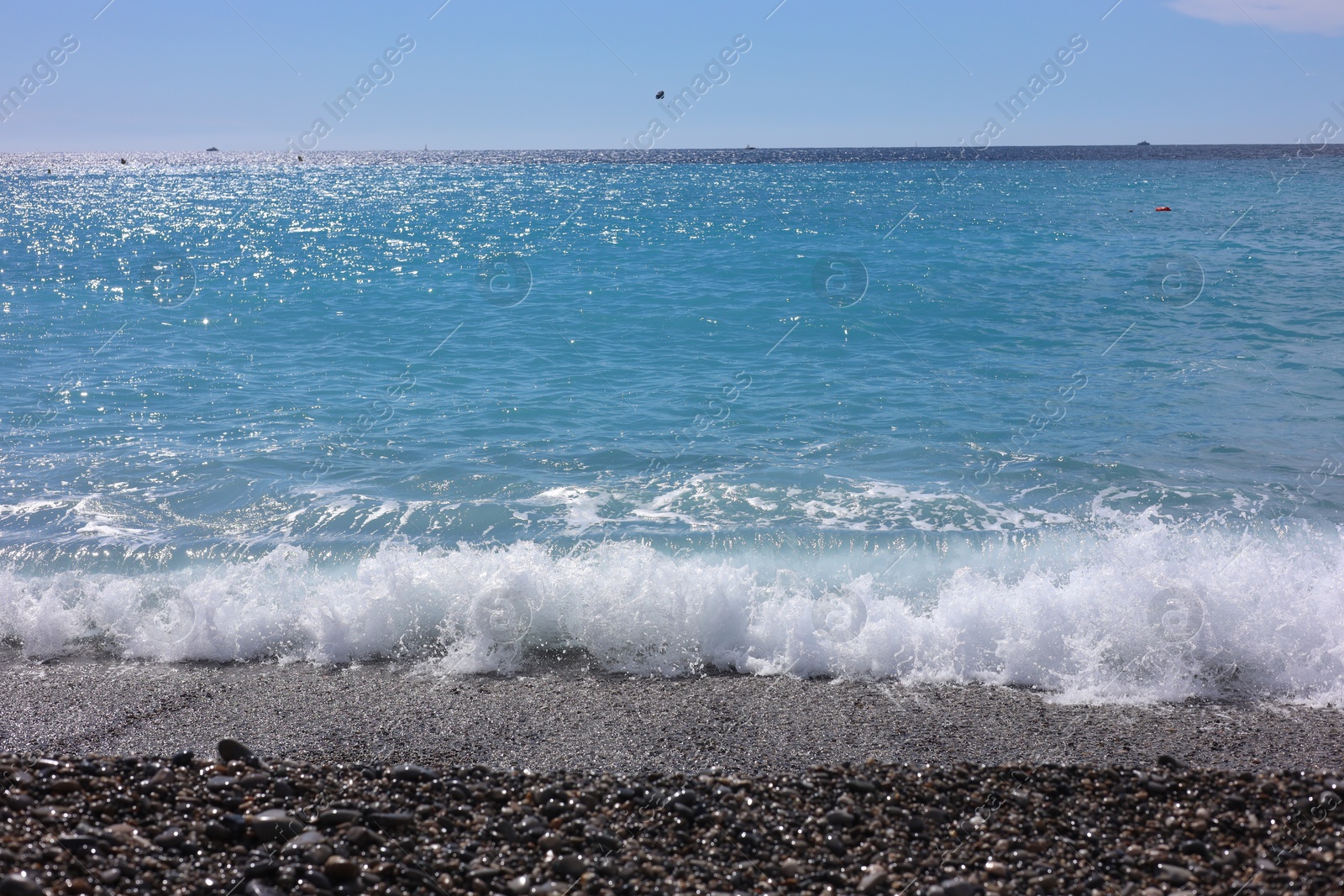 Photo of Beautiful view of wavy sea and pebbles on beach