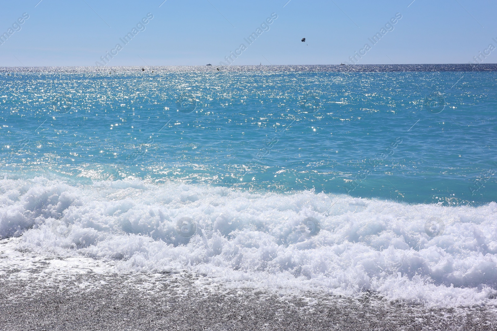 Photo of Beautiful view of wavy sea and pebbles on beach