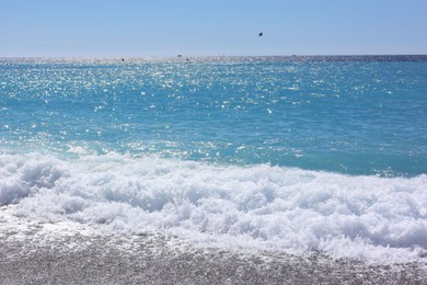 Photo of Beautiful view of wavy sea and pebbles on beach