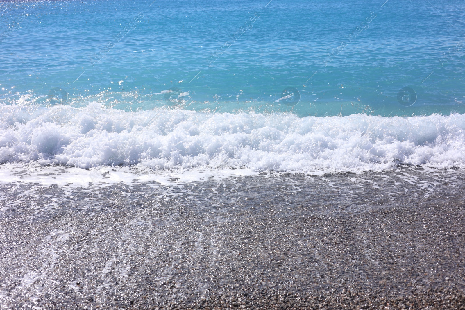 Photo of Beautiful view of wavy sea and pebbles on beach