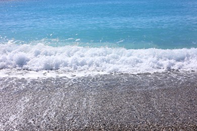 Photo of Beautiful view of wavy sea and pebbles on beach
