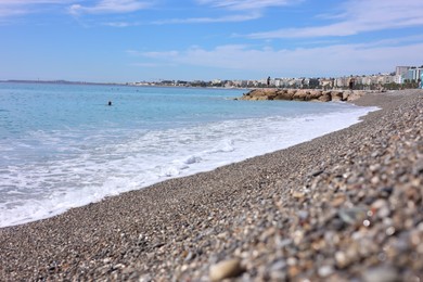 Photo of Beautiful view of wavy sea and pebbles on beach