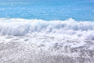 Photo of Beautiful view of wavy sea and pebbles on beach