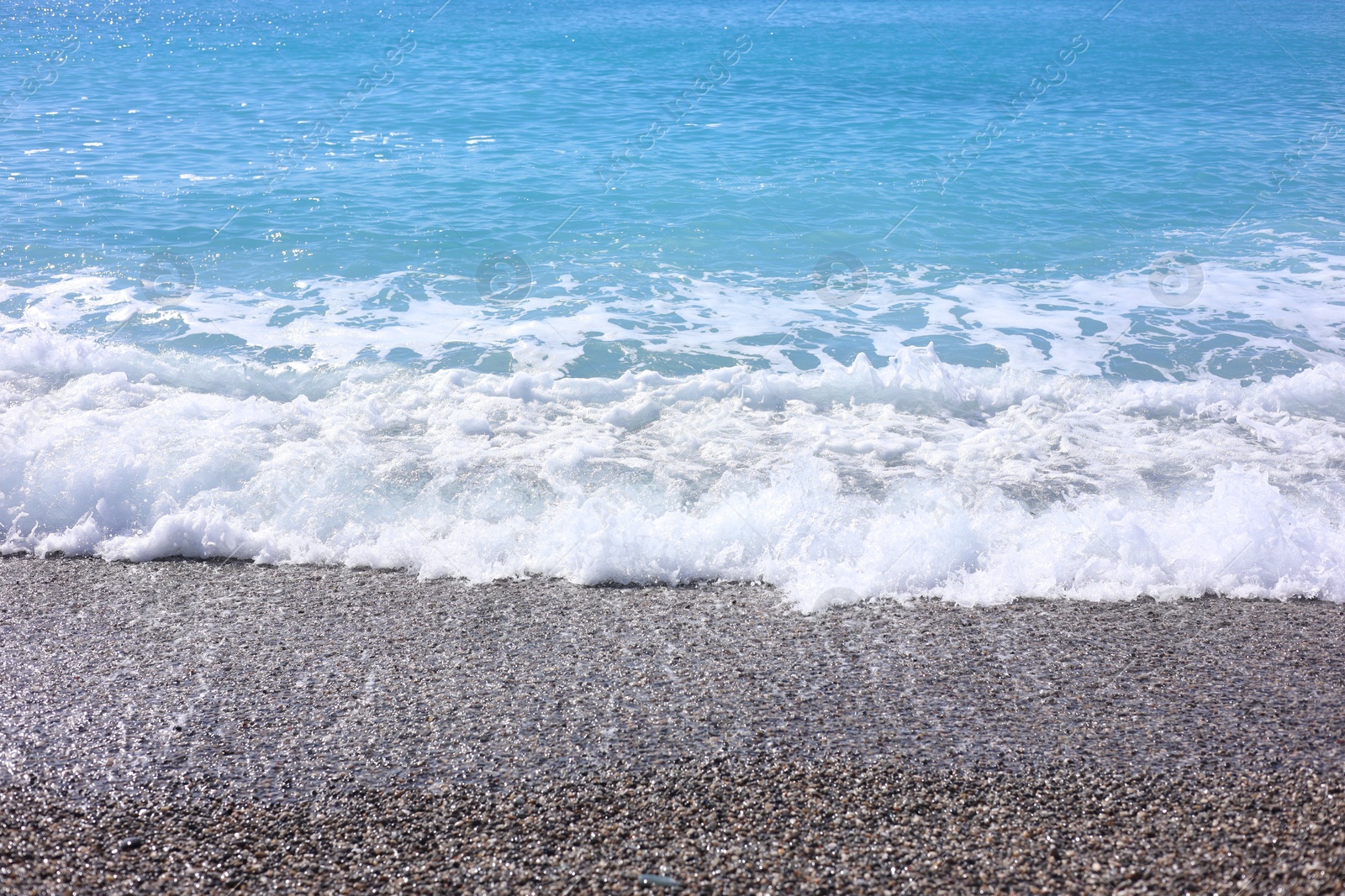 Photo of Beautiful view of wavy sea and pebbles on beach