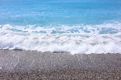 Photo of Beautiful view of wavy sea and pebbles on beach