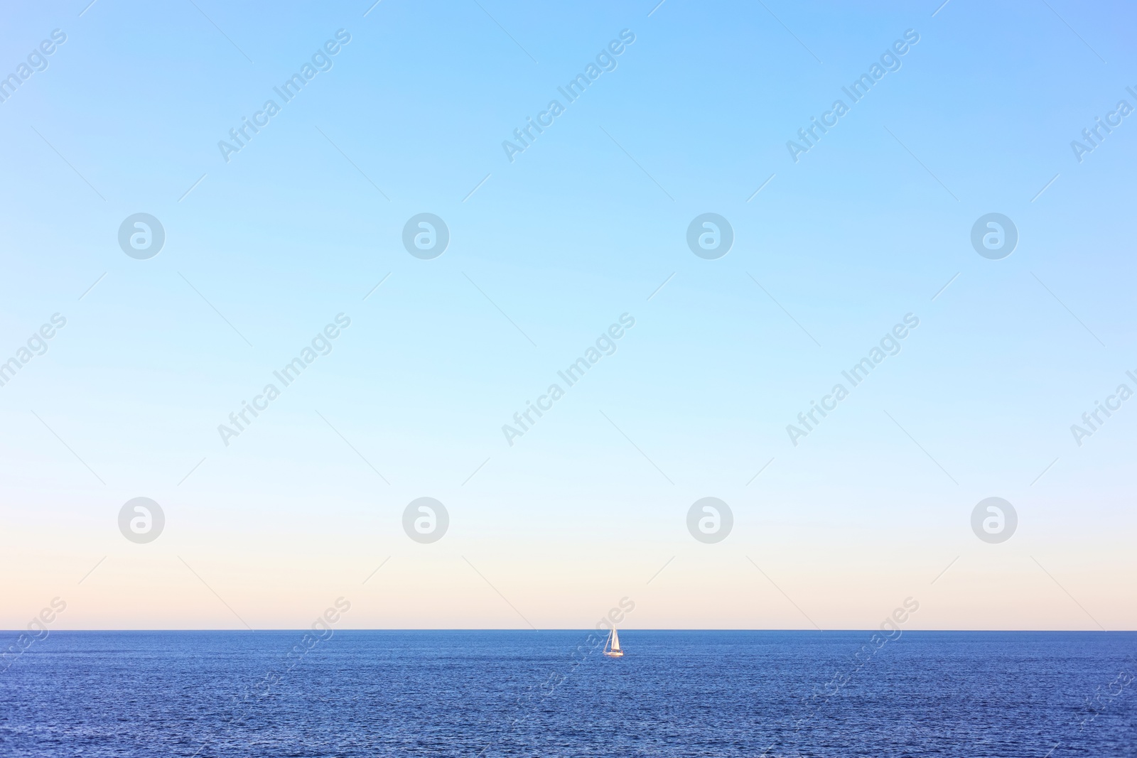 Photo of Calm sea and boat under blue sky