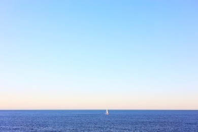 Photo of Calm sea and boat under blue sky