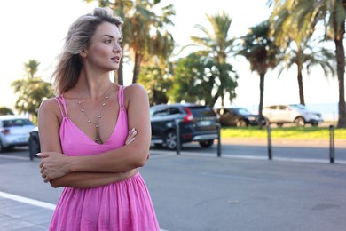 Photo of Portrait of beautiful woman on city street, space for text