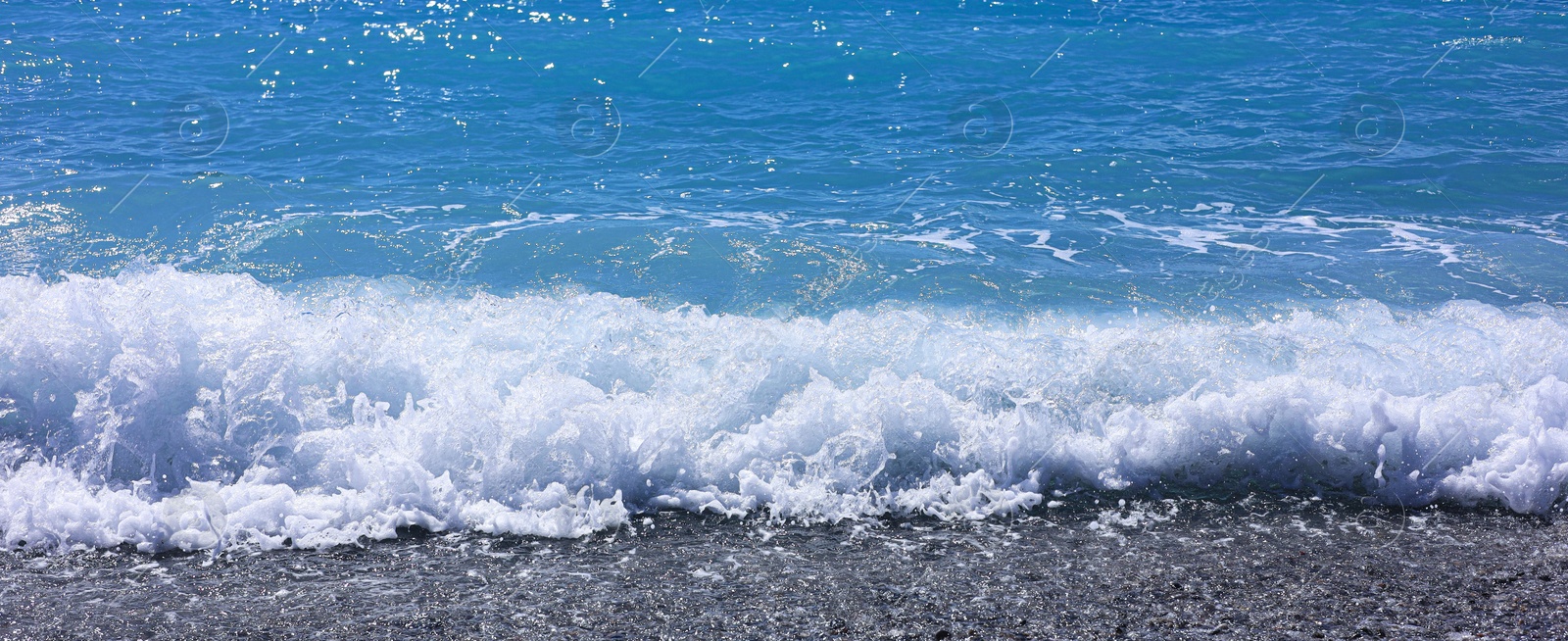 Photo of Beautiful view of wavy sea and pebbles on beach