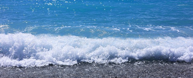 Photo of Beautiful view of wavy sea and pebbles on beach