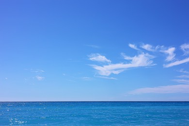 Photo of Airplane flying in beautiful blue sky above wavy sea