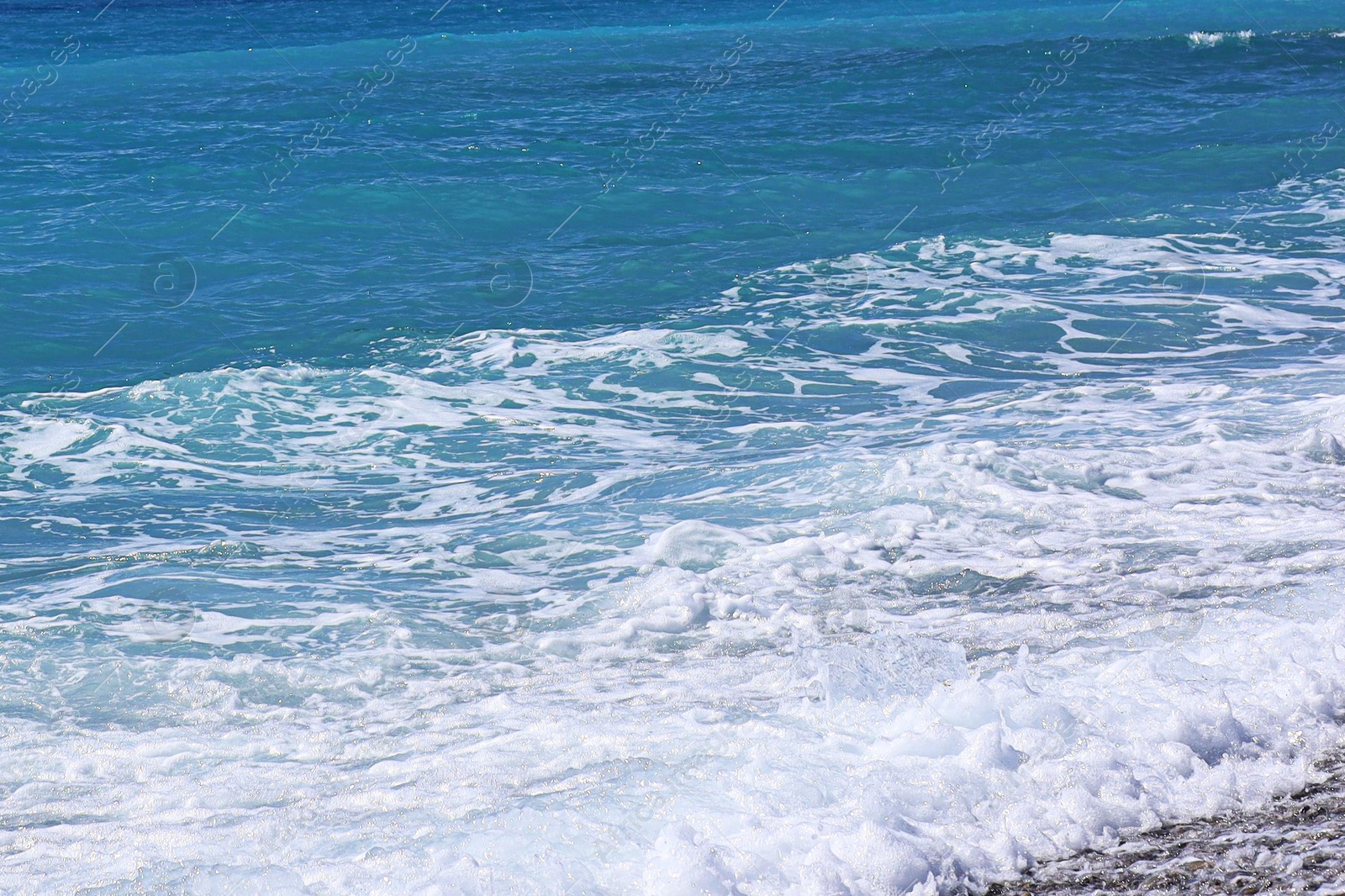 Photo of Beautiful view of wavy sea, city and pebbles on beach