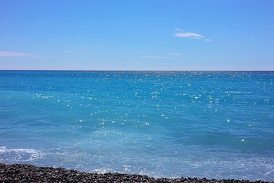 Photo of Beautiful view of wavy sea and pebbles on beach