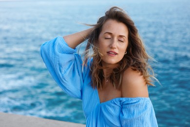 Photo of Beautiful woman near sea on summer day