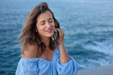 Photo of Beautiful woman near sea on summer day, space for text