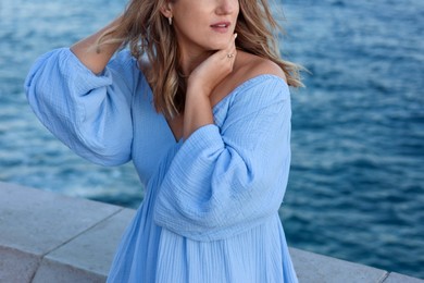 Photo of Beautiful woman near sea on summer day, closeup