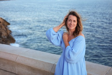 Photo of Beautiful woman near sea on summer day, space for text