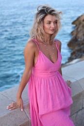 Photo of Beautiful woman near sea on summer day