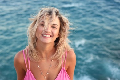 Photo of Beautiful woman near sea on summer day, above view
