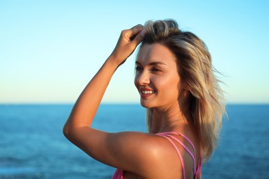 Photo of Beautiful woman near sea on summer day