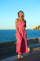 Photo of Beautiful woman near sea on summer day