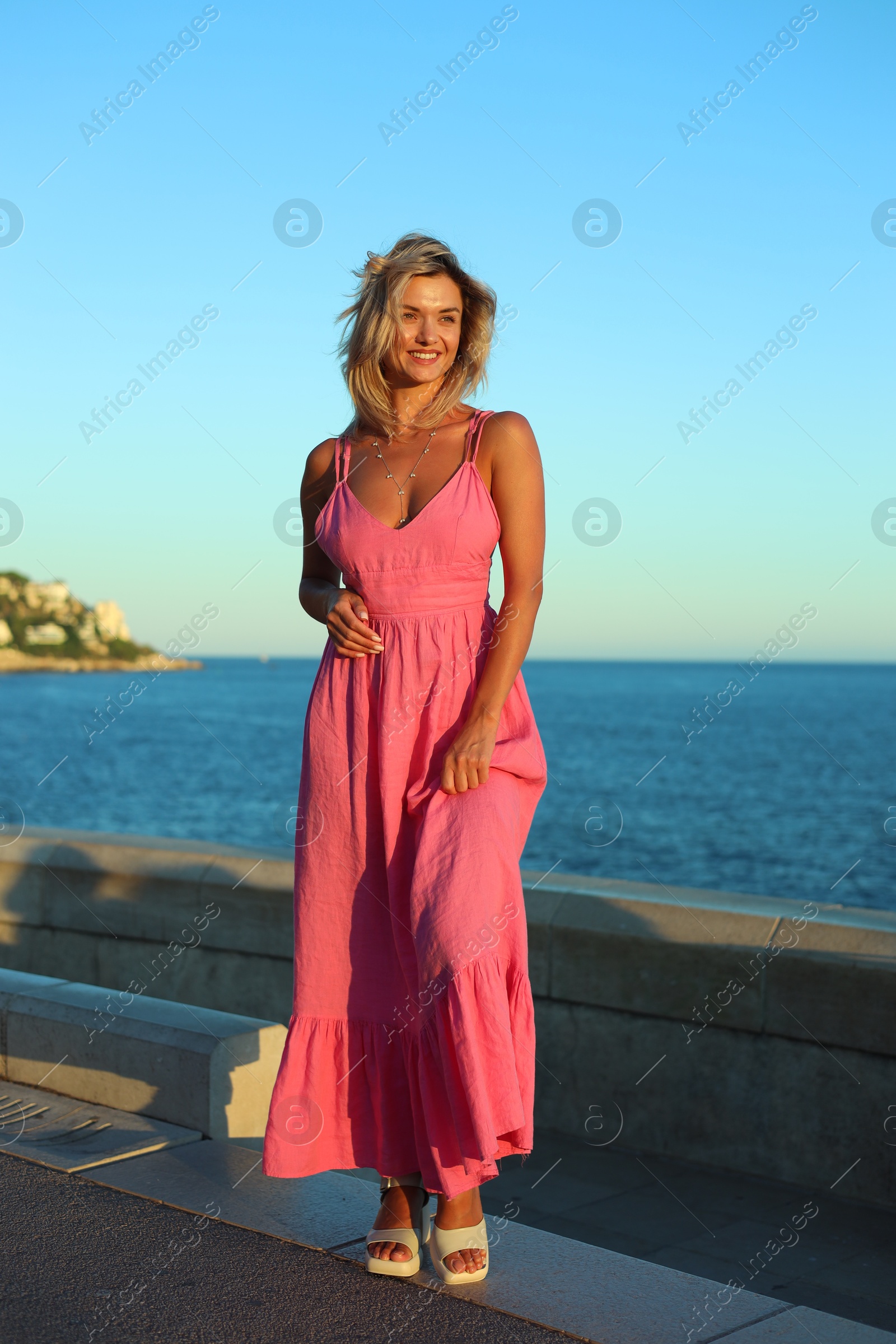 Photo of Beautiful woman near sea on summer day