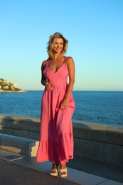 Photo of Beautiful woman near sea on summer day