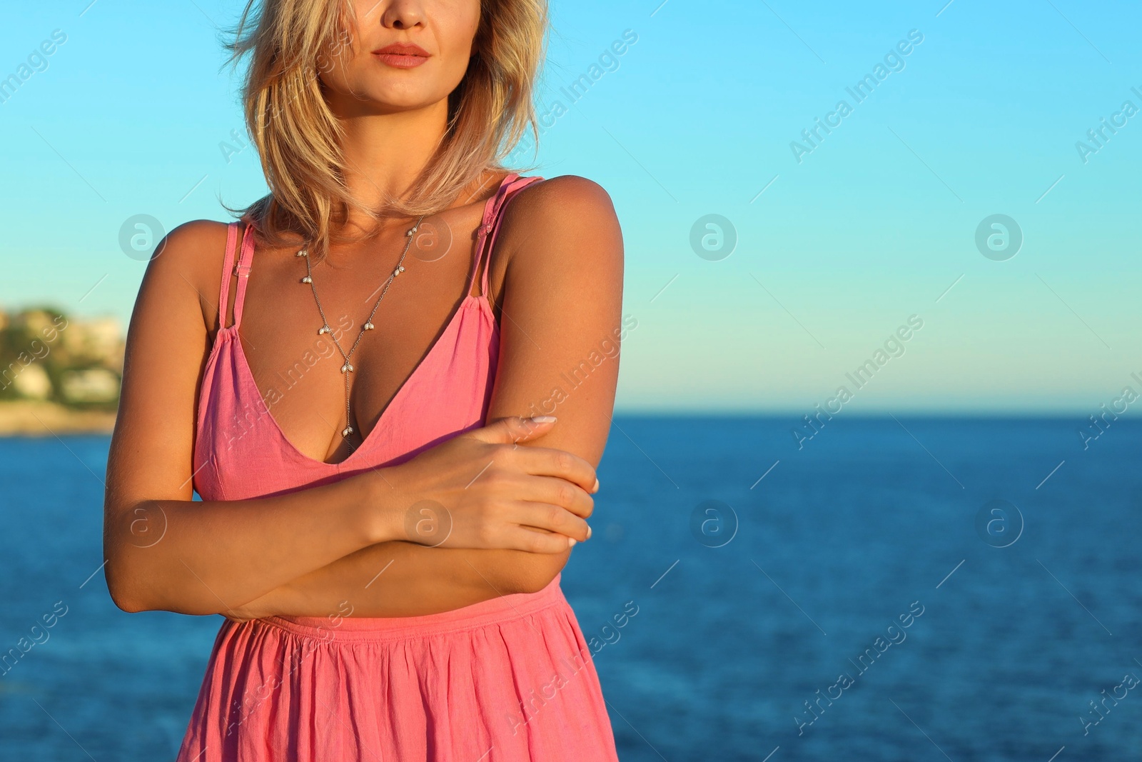 Photo of Beautiful woman near sea on summer day, closeup. Space for text