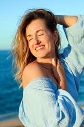 Photo of Beautiful woman near sea on summer day