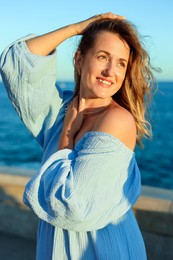 Photo of Beautiful woman near sea on summer day